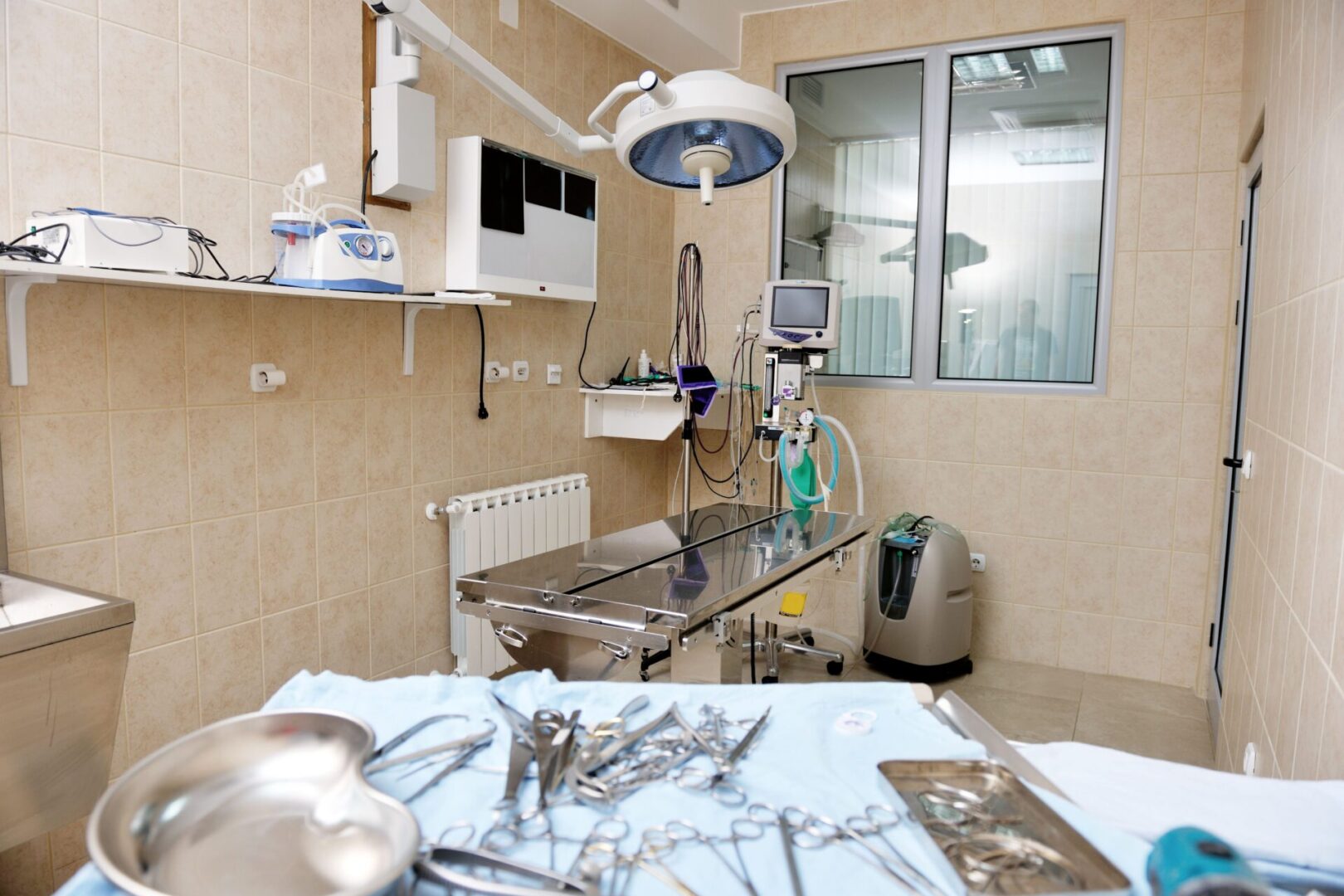 A surgical room with a table and some instruments